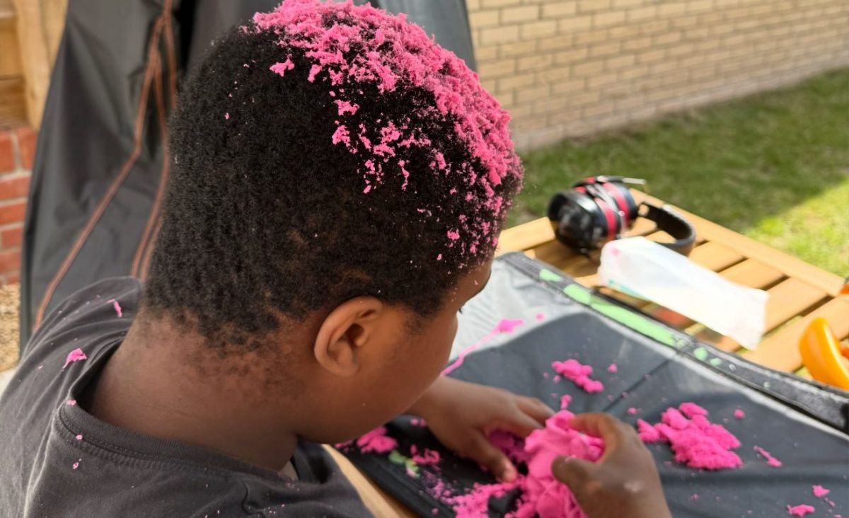 Child engaging in sensory play during autism support session